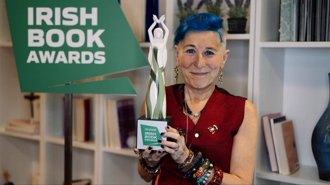 Author Nicola Pierce holding award