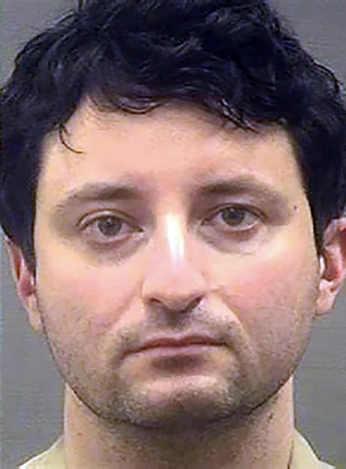 A close-up, front-facing mugshot-style photograph of a man with light skin and dark, slightly wavy hair, photographed against a neutral background. He has a serious, unsmiling expression, visible under-eye shadows, and light facial stubble along the jaw and upper lip. The lighting is flat and utilitarian, consistent with law-enforcement or court intake photography. This image is widely circulated in media coverage related to the 2016 Bitfinex Bitcoin hack, in which nearly 120,000 Bitcoin were stolen and later traced by U.S. authorities. It appears alongside reporting published on January 2, 2026, when U.S. officials confirmed the early release of the individual convicted of laundering the stolen Bitcoin, following a five-year federal sentence reduced under U.S. sentence-credit and prison reform provisions signed into law by President Donald Trump. The image provides factual visual context for reporting on cryptocurrency crime, blockchain investigations, and recent legal developments