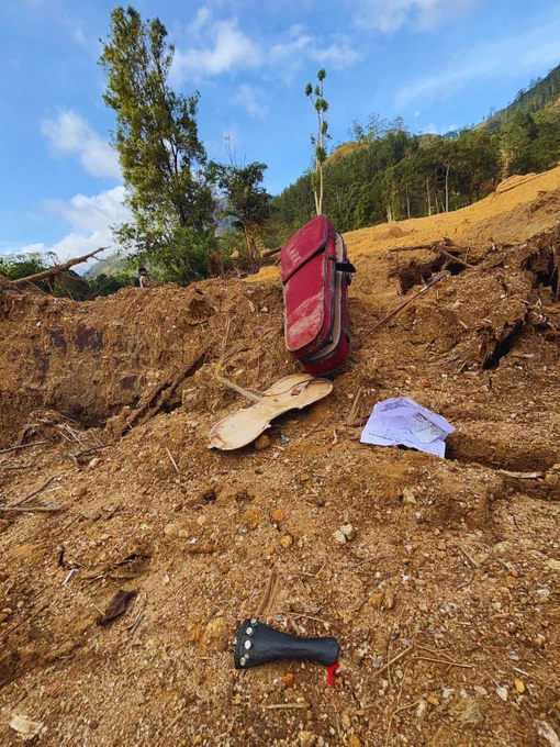 Photo 03: A broken Lark Red Violin lies among the debris of a destroyed home at the lower edge of the brutal Rambodagama landslide near the Kotmale Dam in Kotmale Valley. Once likely belonging to a schoolchild, it now remains an eternal silent note, a haunting reminder of lives and childhoods lost in the disaster.This photograph was taken on 27 December 2025, exactly one month after the tragedy.