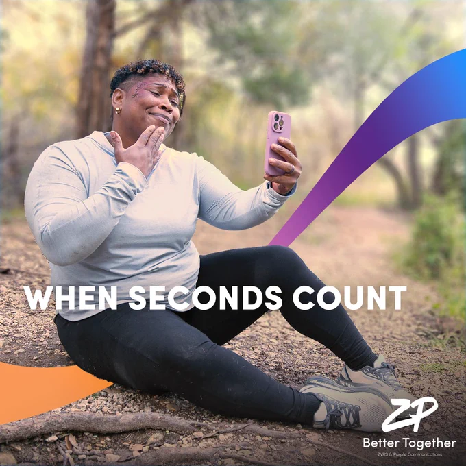The image shows a Black woman in black leggings and a grey sweatshirt, with blood on her face, signing “thank you” to someone on her iPhone. She’s sitting on the ground in a woodsy area. Under her is an orange, purple and blue ombre banner. Over her, in white text, are the words “When seconds count”. At the bottom right is the ZP Better Together logo in white