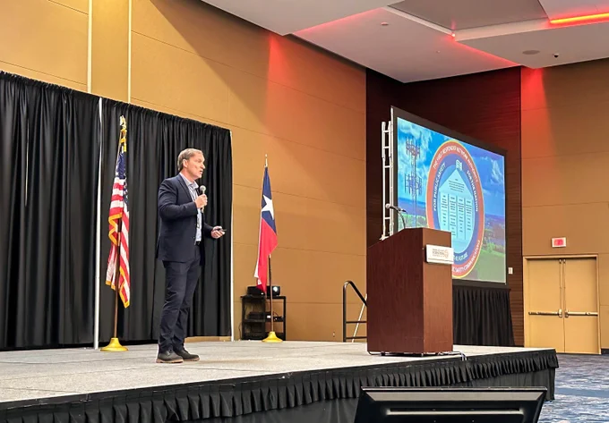 FirstNet Authority CEO and Executive Director Joe Wassel giving a speech on-stage at the IAFC TSI Conference. 