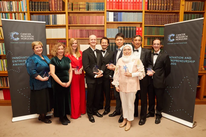 Group of winners posing together for a photo at the I&E Awards. 