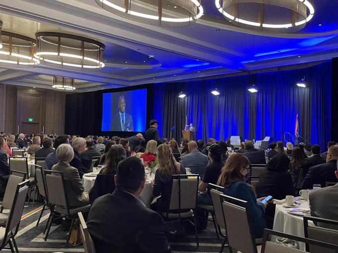 Tempe mayor Corey Woods speaks to a packed ballroom