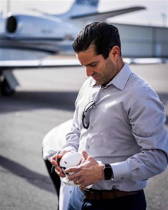 New head coach Manny Diaz signs a Duke football mini helmet as giveaway item.