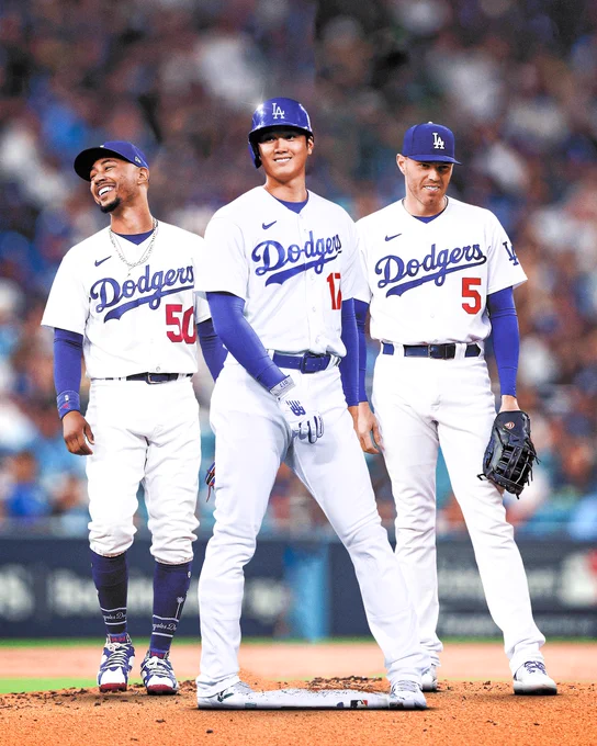 Cutout of Shohei Ohtani Photoshopped into a Dodgers uniform in between his new teammates, Mookie Betts and Freddie Freeman.