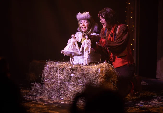 Performers: Nia Davies, Jack Friars.
Image Description: Nia as a sheep and Jack as a horse perform an enchanting puppet show on a hay bale to the young audience.