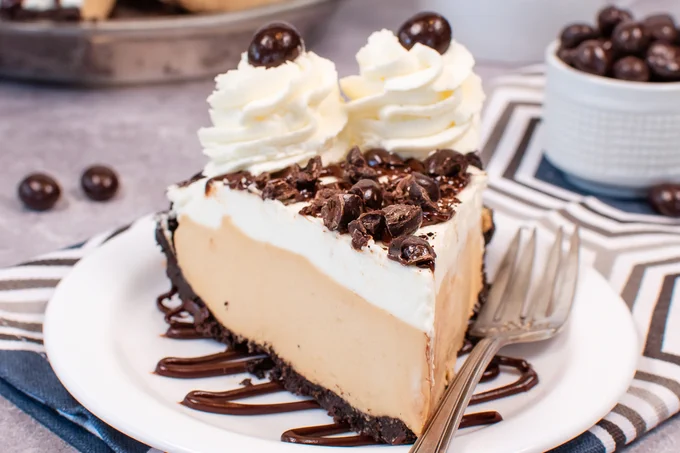 A slice of mousse pie on a white plate.