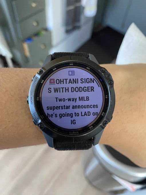 Garmin watch with text of alert siren and all caps Ohtani Signs with Dodgers. Caption Two-way MLB superstar announces he’s going to LAD on IG