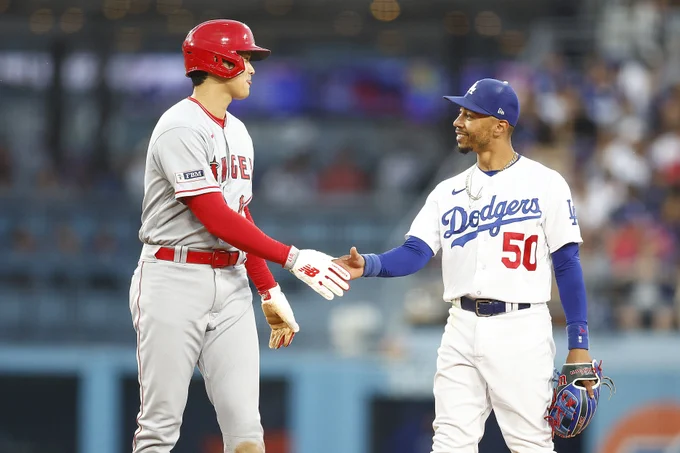 Mookie Betts smiles as he looks at Shohei Ohtani.