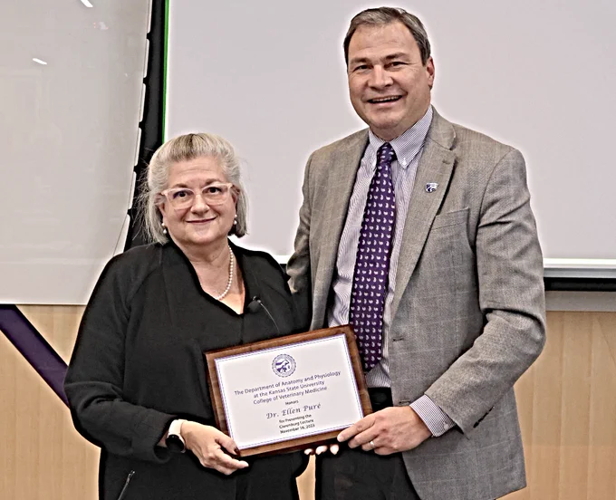Clarenburg Lectureship speaker Dr. Ellen Puré, of the University of Pennsylvania, received a plaque from Dr. Hans Coetzee on Nov. 16 following her talk at the College of Veterinary Medicine on the KSU campus in Manhattan.