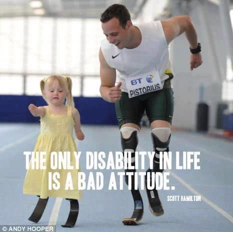 Oscar Pistorius with a disabled child under a Scott Hamilton quote, “The only disability in life is a bad attitude.”