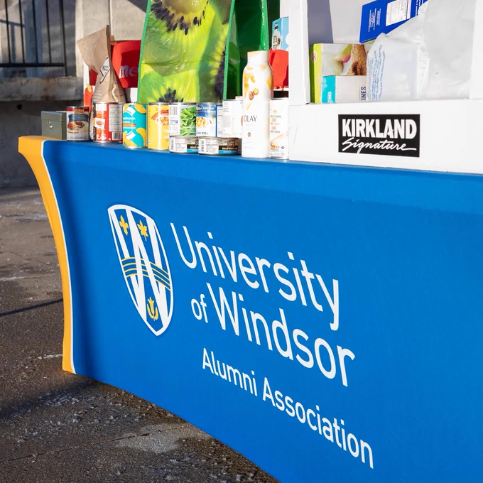 Table with UWindsor table cloth holding food donations.