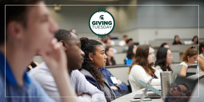Students in a classroom with the GivingTuesday logo over top