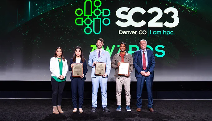 five people stand onstage at SC23