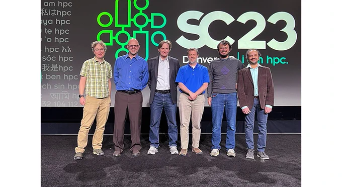six people stand onstage at SC23
