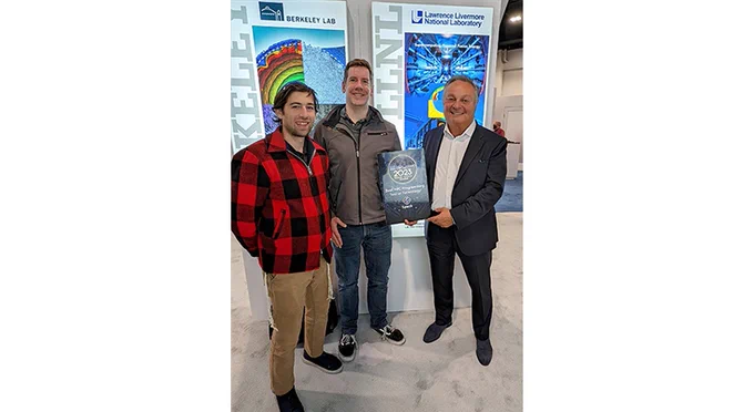 three people stand with the HPCwire award