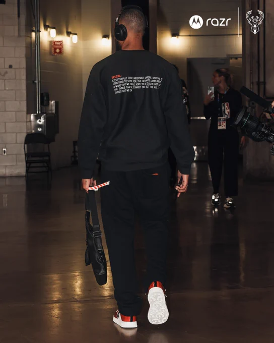 A photo of Damian Lilliard from behind as he walks into the Kaseya Center in Miami wearing a black sweatshirt with the definition of "special" on it in support of Special Olympics athletes.