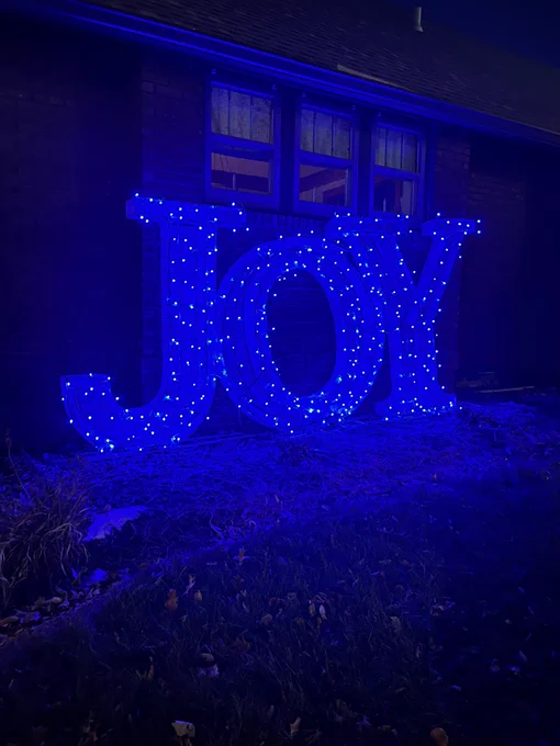 This is an outdoor 6 foot JOY holiday decoration with blue lights.