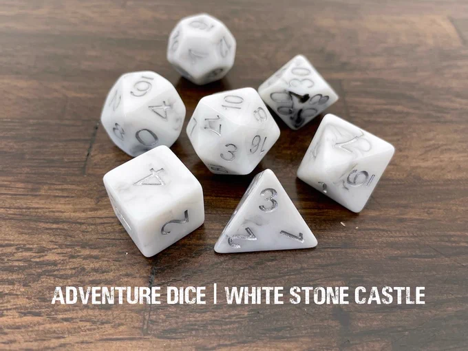 Whitestone Castle rpg dice set are opaque white with wisps of grey, and silver numbering.