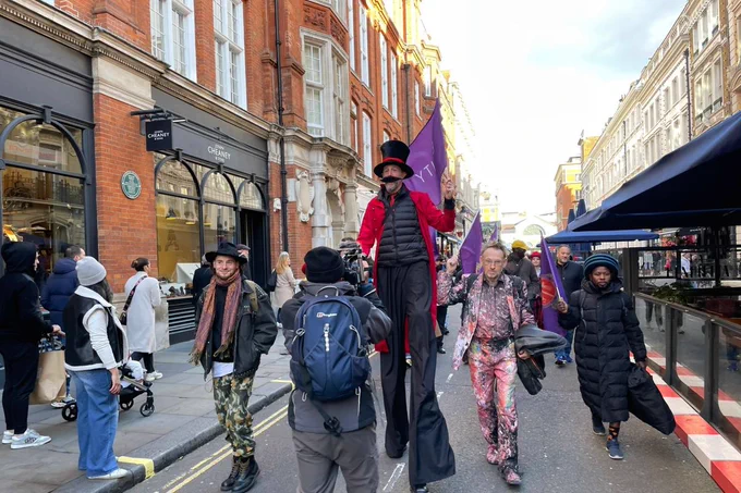 Street performers walking along a street to deliver a petition. Credit: Equity UK