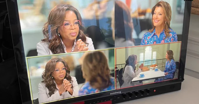 A monitor displays scenes of a conversation between two women.