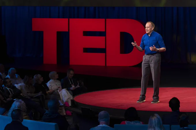 Steve Long speaking on a stage with the word TED behind him.