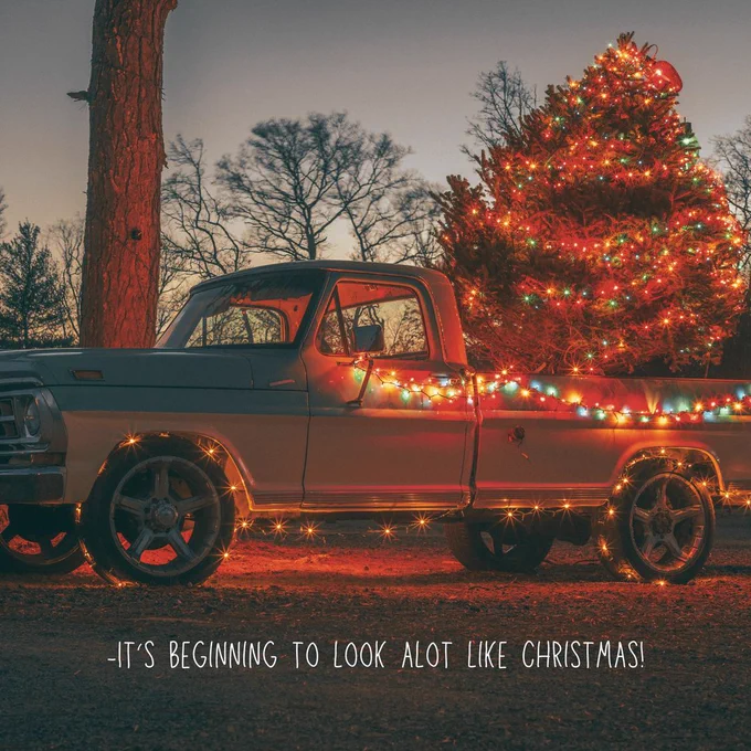 a old truck with colorful christmas lights with the words "its beginning to look alot like christmas" in white text