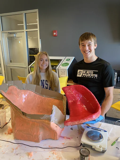 CTEC CAPS students, Isabelle Jones and Andrew Parks show off their newly learned mold-making skills. A team of students have been applying coats of silicone rubber that will then be covered with a fiberglass and resin shell called the "mother mold". Once complete, the mold is taken apart and the interior sculpture of the adaptive shower chair is removed. Next, the mold is reassembled and an ready to accept a foam casting material. The final casting will receive a protective waterproof coating pigmented pink which is the child recipient's favorite color. Way to go, team!!!!