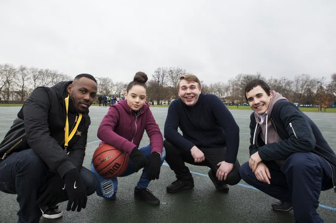 Four people on a sports playground