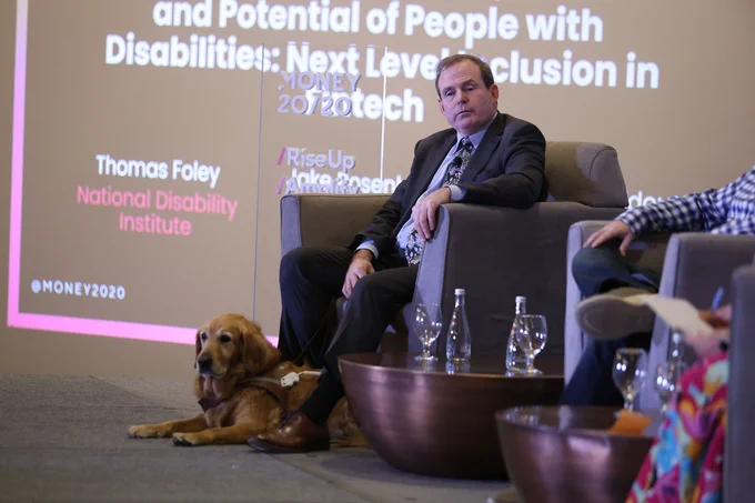 Three photos of Tom Foley with his service dog, Alabama, sitting in an armchair on a stage joined by two other presenters at the Money 20/20 Event. Behind Tom is a projected slide showing the title of the conversation: Capitalizing on the Talent and Potential of People with Disabilities. 