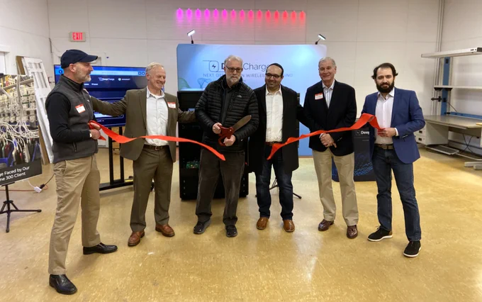 Mayor Casavant cuts a red ribbon in front of a DeepCharge sign. He is joined by Mayor-Elect Marty Grohman, Economic Development Coordinator Brad Favreau, and the DeepCharge team.