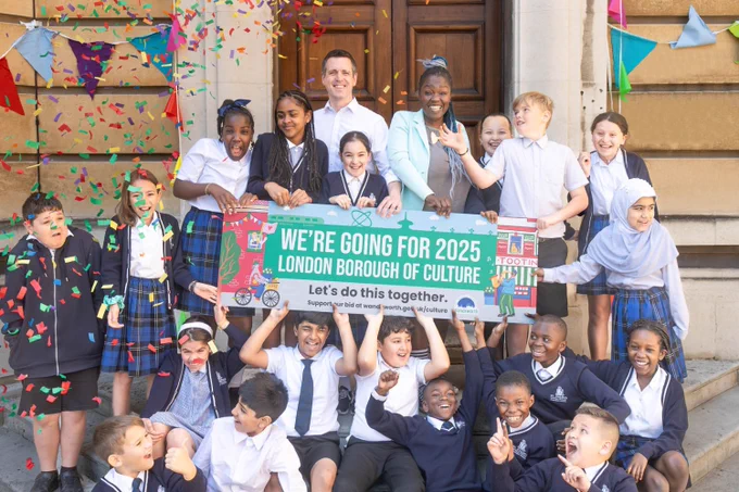 Leader and Cllr Akinola on the town hall steps with the borough of culture banner