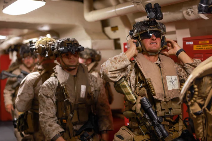 U.S. Marines assigned to Charlie Company, Battalion Landing Team 1/5, 15th Marine Expeditionary Unit, stage in a passageway aboard the amphibious transport dock USS Somerset (LPD 25) during a tactical recovery of aircraft personnel mission walkthrough while underway in the Pacific Ocean, Nov. 16, 2023. The 15th MEU is currently embarked aboard the Boxer Amphibious Ready Group conducting integrated training and routine operations in U.S. 3rd Fleet. (U.S. Marine Corps photo by Cpl. Aidan Hekker)