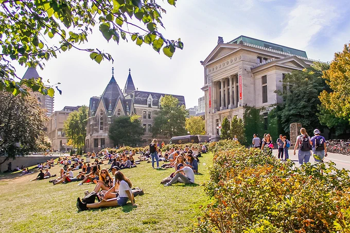 Students lounging on "the beach" in front of Redpath Museum. Valeria Lau | McGill University (April 2018)