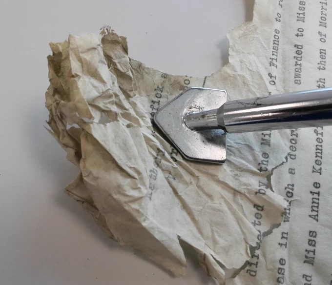 Creases being smoothed with a heated spatula