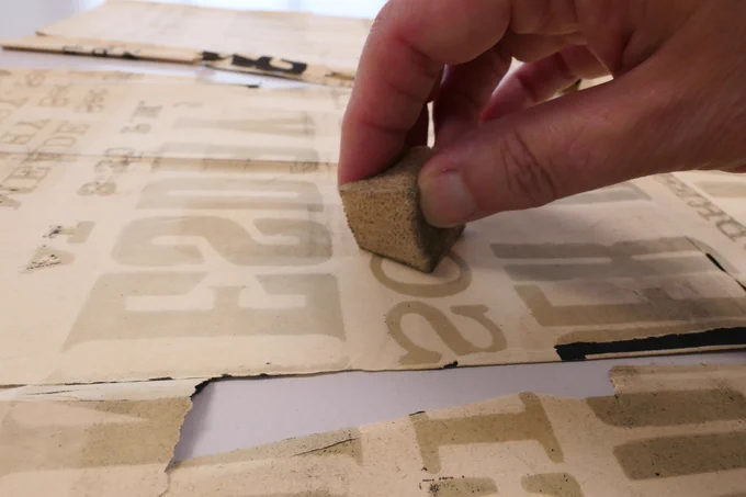 Poster being cleaned with a smoke sponge