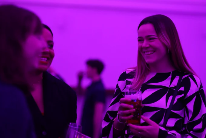 Image from the 2022 version of the Emerging Theatre Makers Celebration event - a group of people smile together, holding drinks.