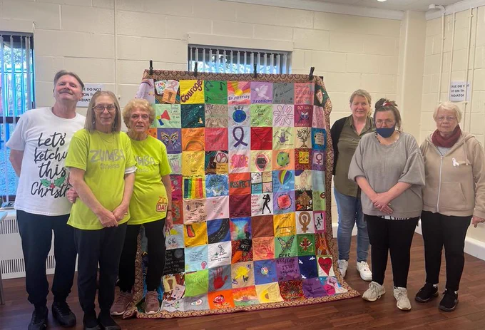 Volunteers and residents pictured with the Quilt of Hope at Jubilee Park Community Centre in Tipton
