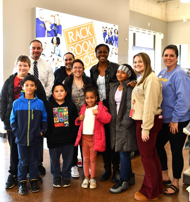 group of adults and children at rack room shoes