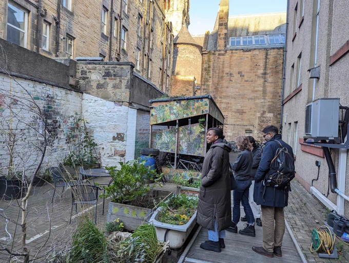 Students view the Edinburgh Student Housing Co-op's courtyard and bike rack.