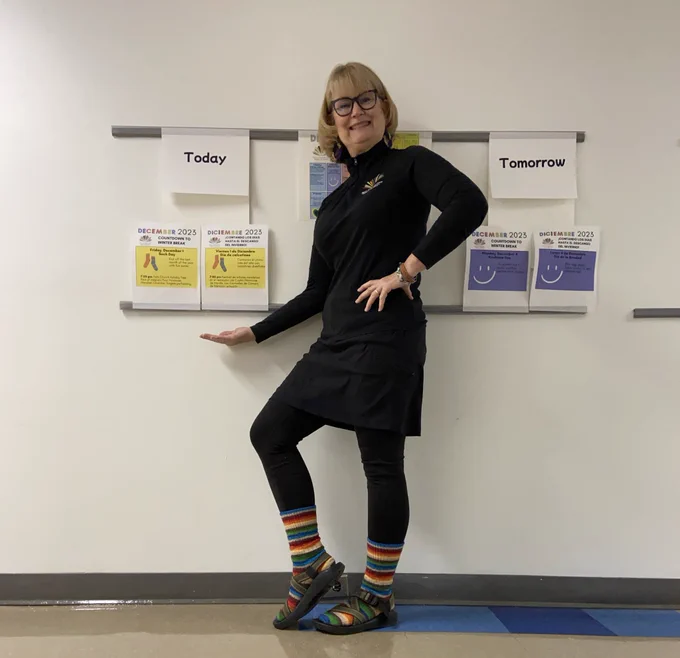 Woman dressed in black with multi-colored socks