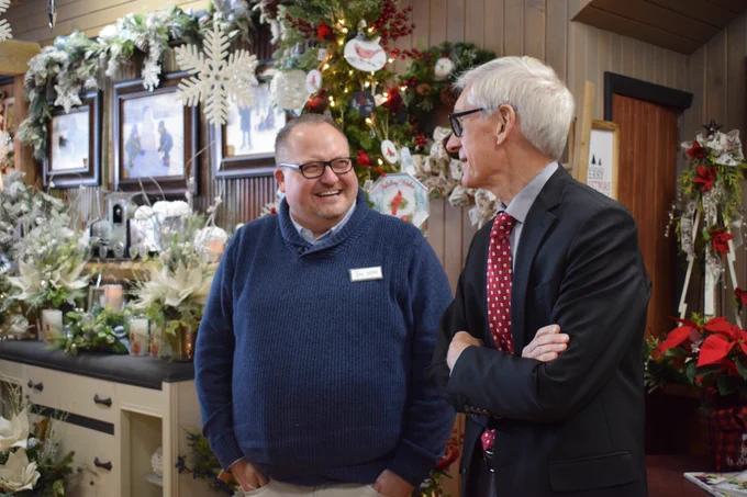 Gov. Evers talks with shop owner at his floral business in downtown Antigo.
