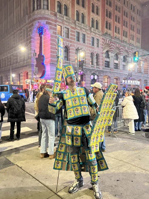 Shawn posing next to a parade he just crossed through