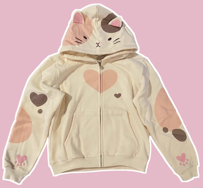 Zip up hoodie with calico pattern, paw prints on the hands and and face with ears on the hood