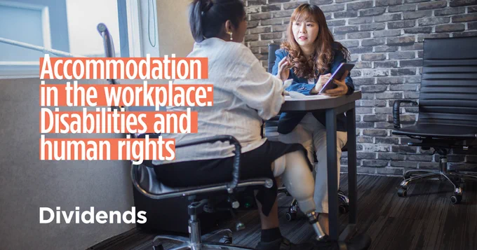 Two individuals seated at a table: one has a visible prosthetic leg and is conversing with another holding a tablet. Text: Accommodation in the workplace: Disabilities and human rights.