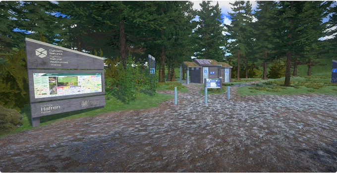 A digital shot of the virtual reality experience uploaded into the VR headsets. The shot shows a display sign from Natural Resources Wales to the left. Ground from the right gives way to grass and trees as it leads to the background and centre of the shot where there is a hut.