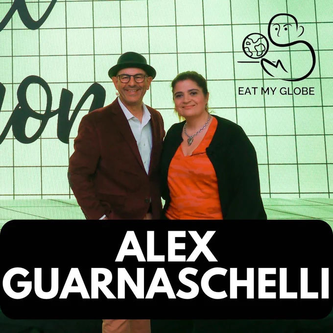 Simon Majumdar and Alex Guarnaschelli standing next to each other. Includes the text, “Alex Guarnaschelli.” Also includes the Eat My Globe logo of Simon Majumdar's likeness using the initials "S" and "M" holding a globe on a platter with the words, "Eat My Globe," underneath.
