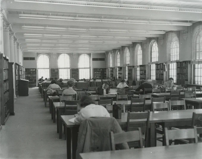 Students study in the Reference Room on the main floor of the Library. Black and White photograph