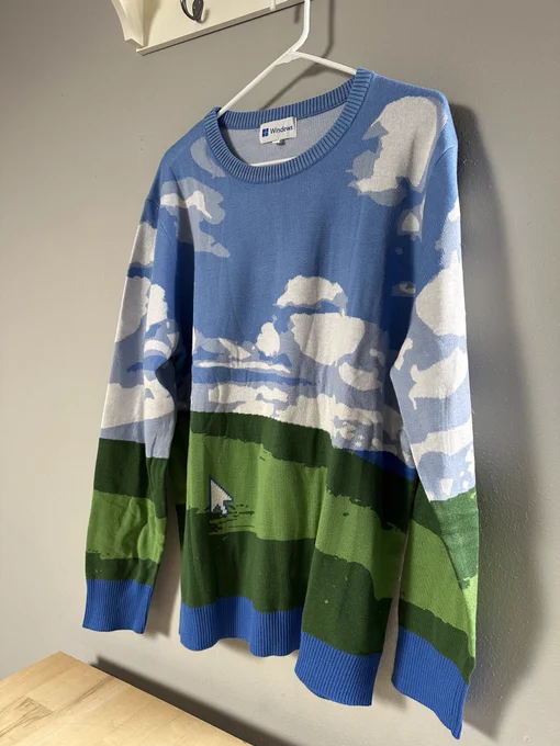 A Christmas sweater with the Windows XP Bliss hill photo filling the whole design. In the lower left is a white mouse cursor.