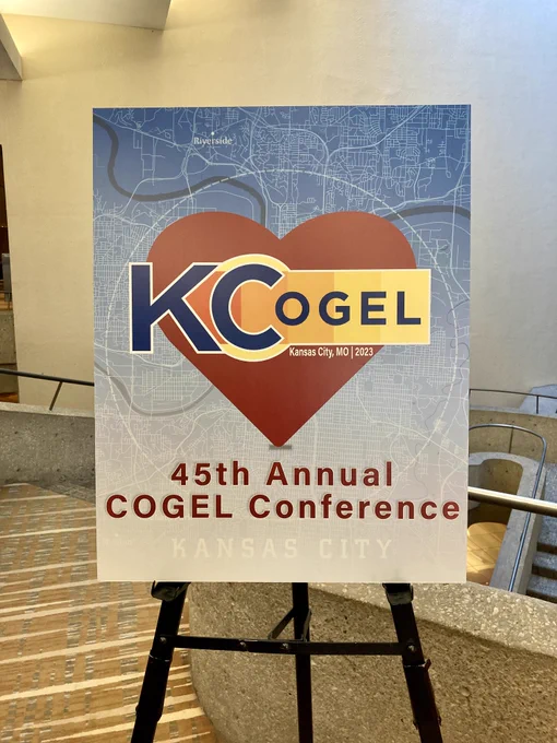 Poster board with COGEL logo surrounded by a heart.